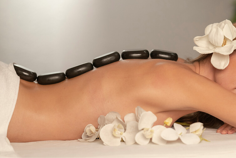 woman with lava stones on her back